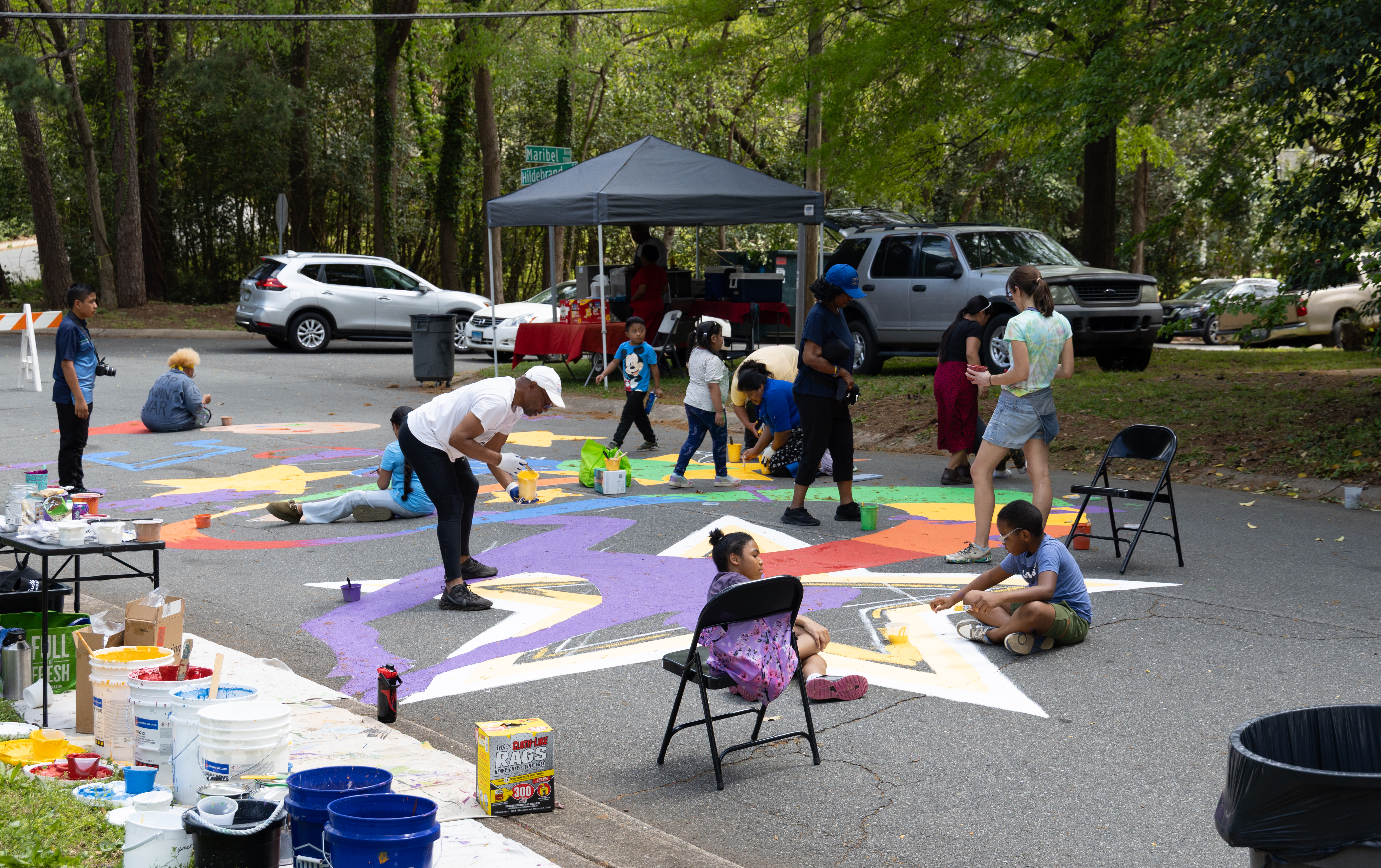Community members paint street mural at school entrance