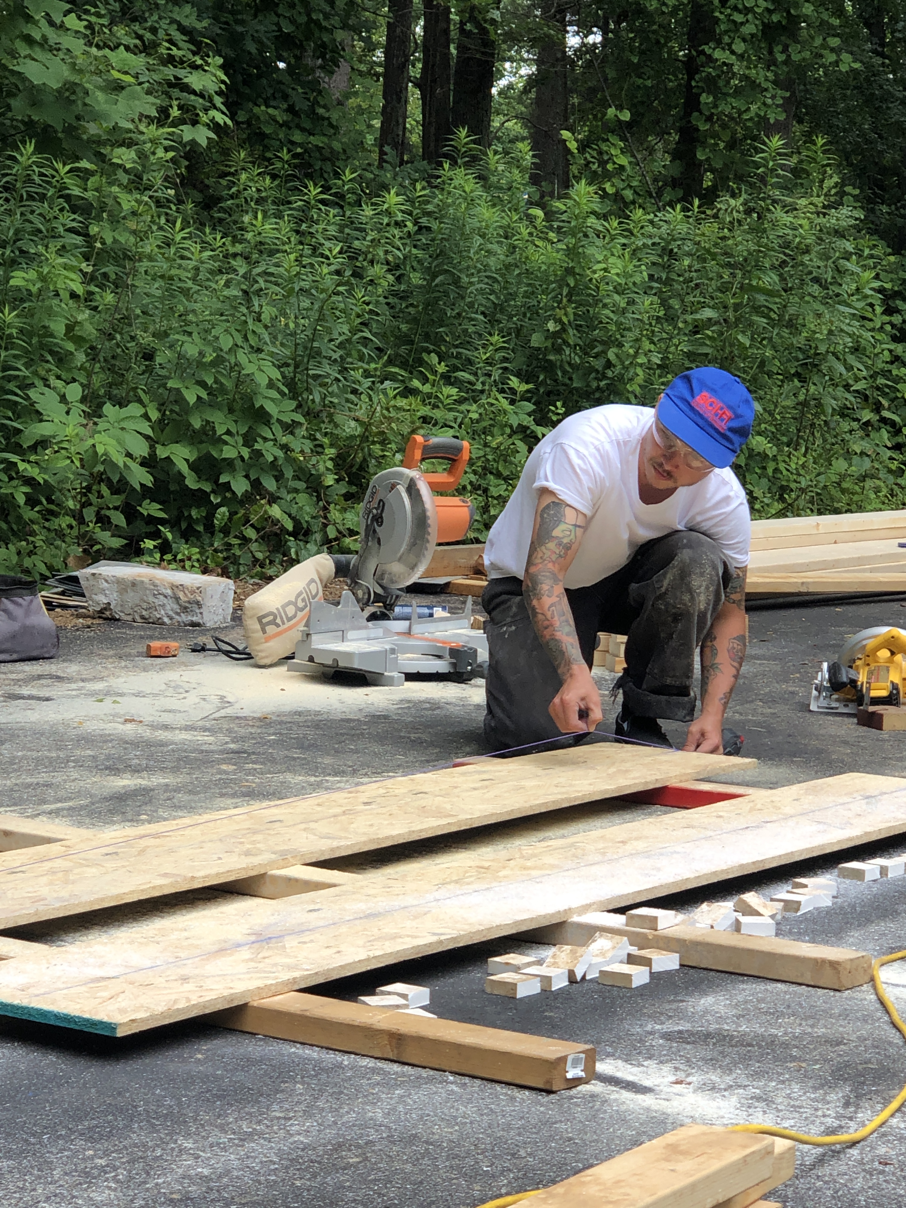 Man builds wood framing for a skatepark ramp