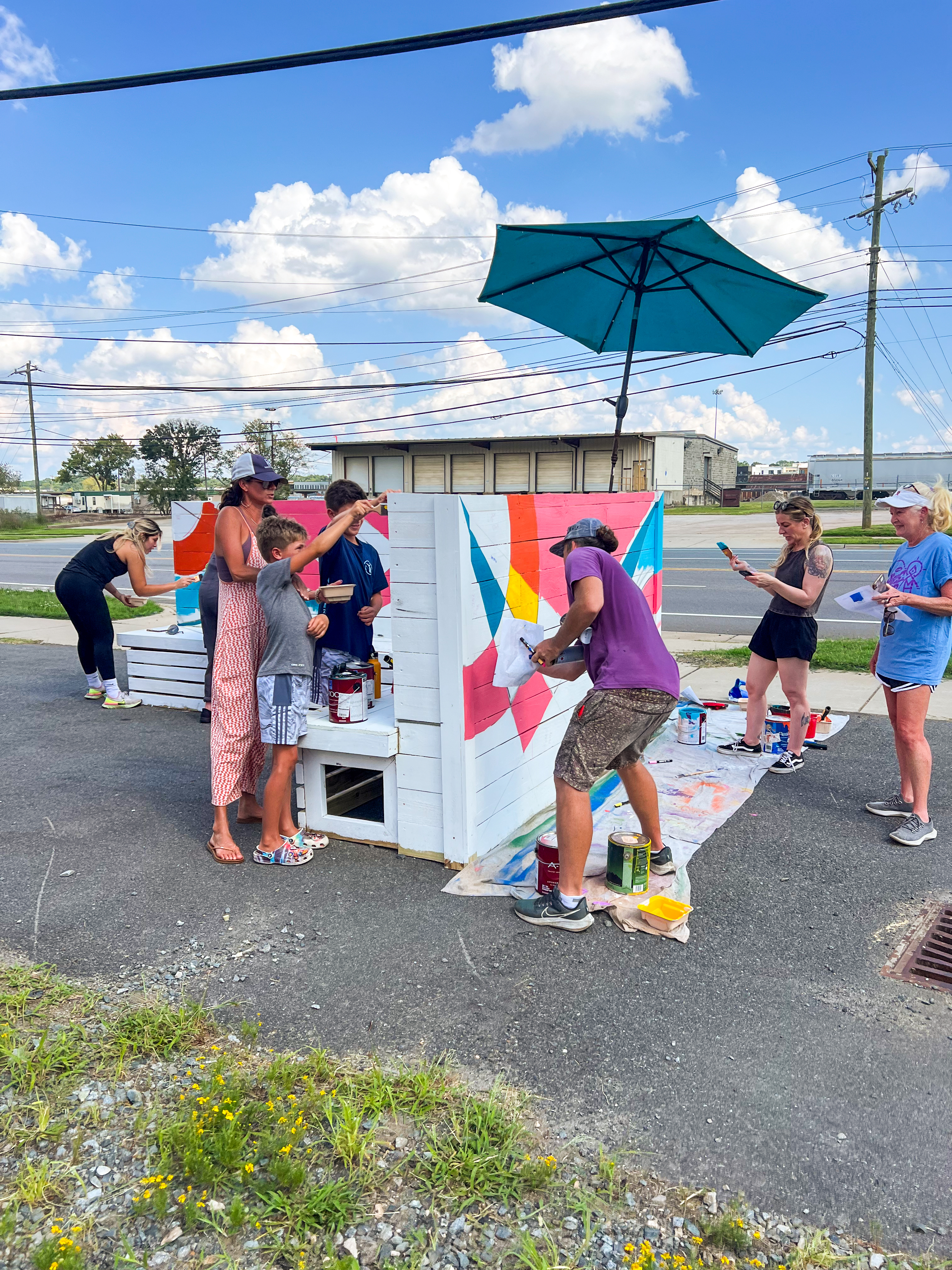Community paints seating in a new public space on Tryon Street