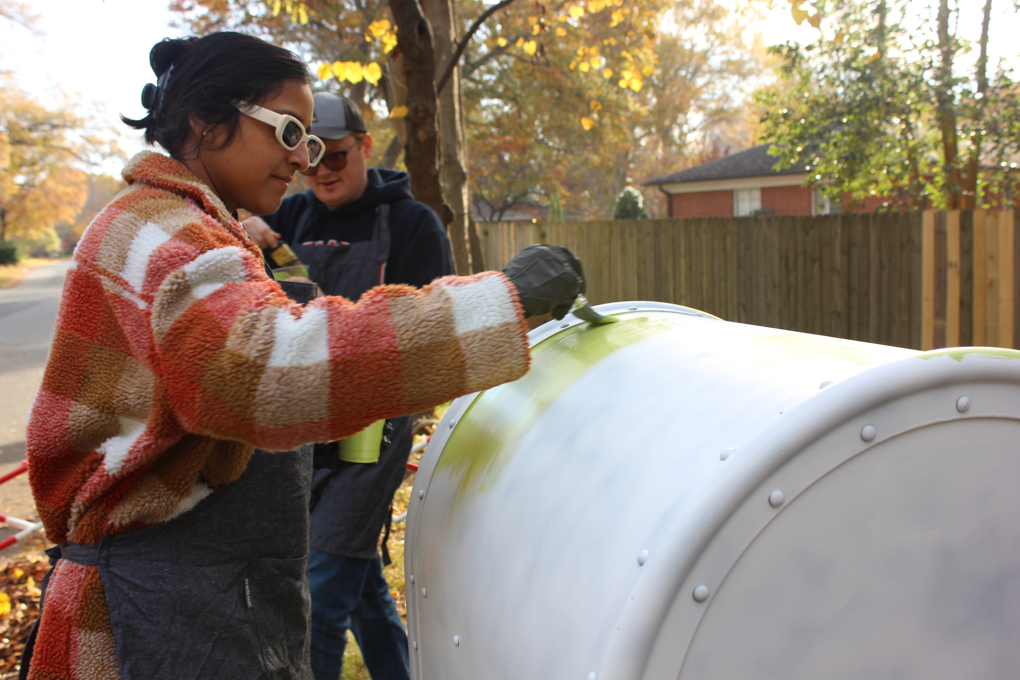 Woman adds base paint to a decommissioned mailbox in medford acres neighborhood